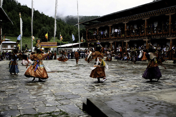 Tourist group in Bhutan rushing through multiple attractions in a single day, depicting an overloaded travel schedule.