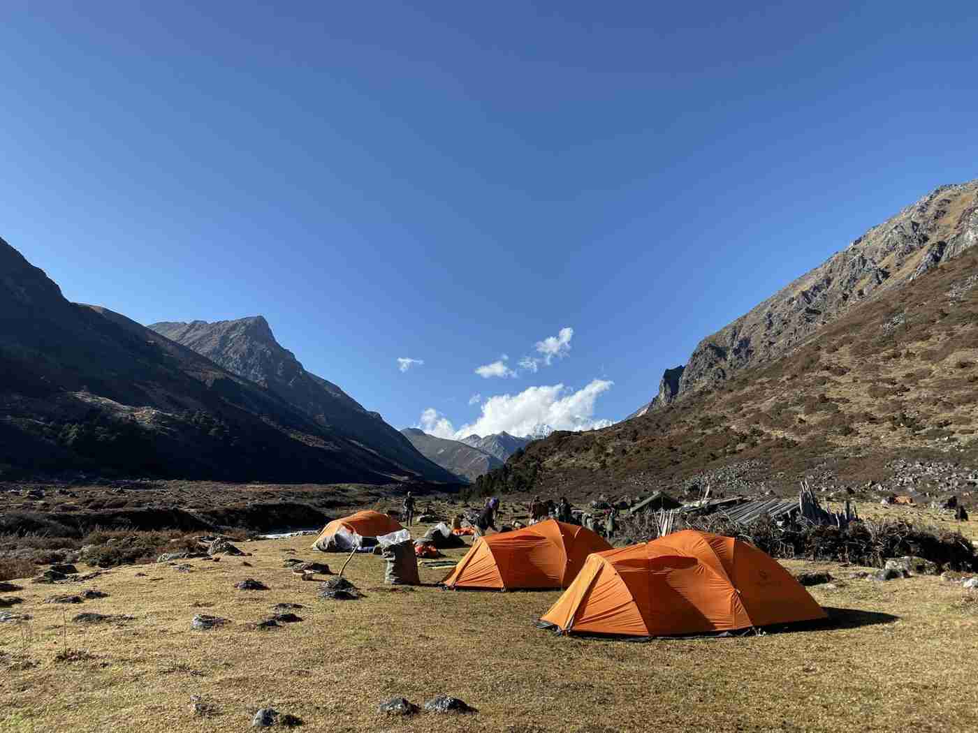 Damnongchu campsite on the Snowman Trek in Bhutan surrounded by rugged mountains and alpine landscape.
