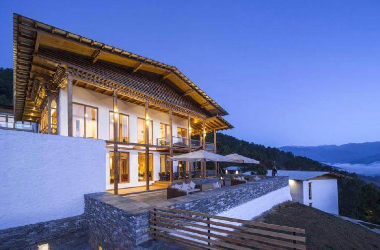 Densa Boutique Resort in Punakha Bhutan surrounded by lush green valleys and peaceful mountain scenery.