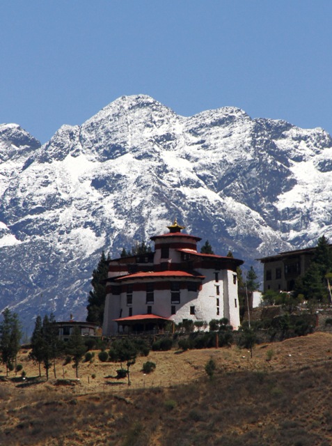 Drukgyel Dzong ruins in Paro Bhutan with Himalayan mountain backdrop.