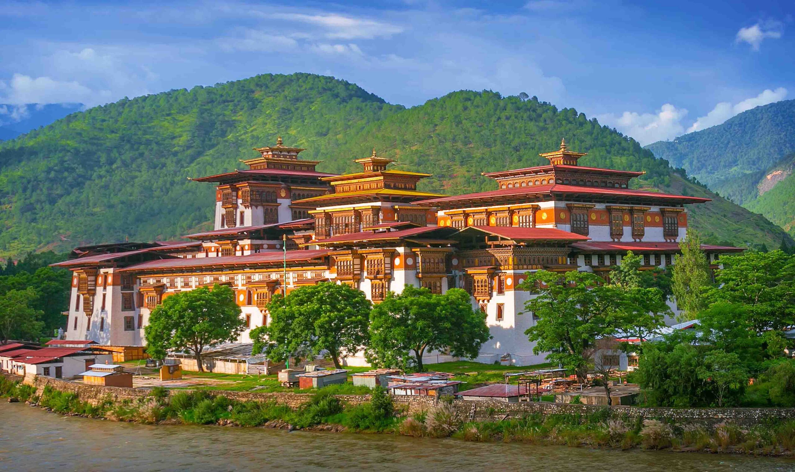 Punakha Dzong in Punakha Bhutan surrounded by rivers and green valley landscap.