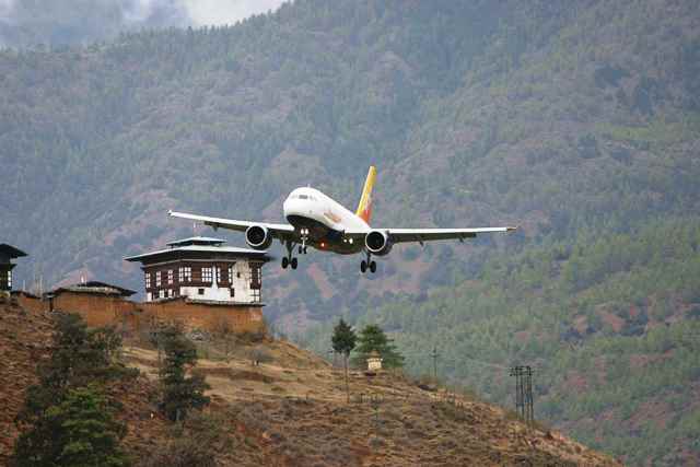 Paro International Airport in Bhutan with traditional architecture and Himalayan mountain views.