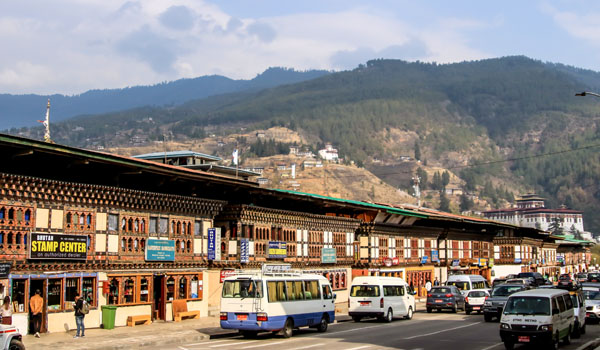 Sang Choekor Buddhist College in Paro surrounded by pine forests and traditional Bhutanese architecture.
