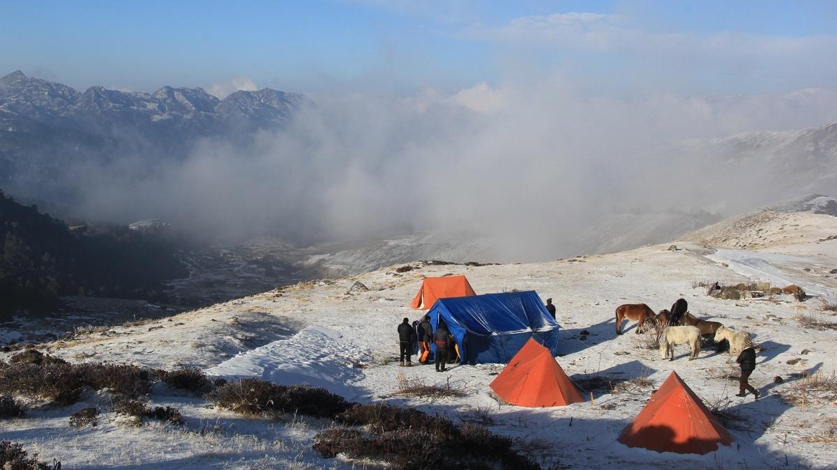 Shomuthang campsite at 4,220m on Bhutan Snowman Trek with Himalayan mountains and alpine landscape.