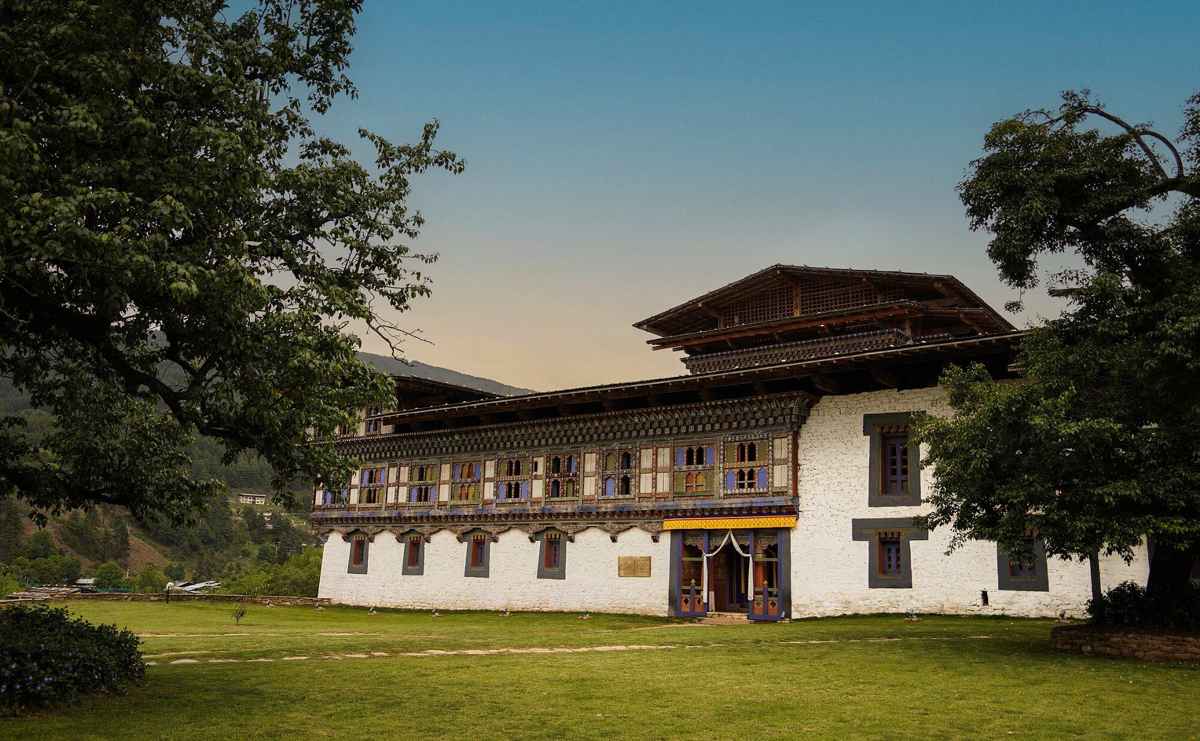 Wangdichholing Palace in Bumthang featuring traditional Bhutanese architecture and landscaped grounds.