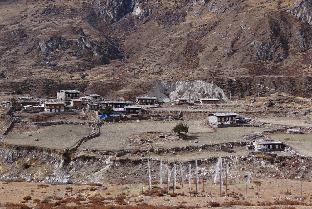 Thanza village in Bhutan with traditional houses, alpine landscapes, and Himalayan mountains along the Snowman Trek.