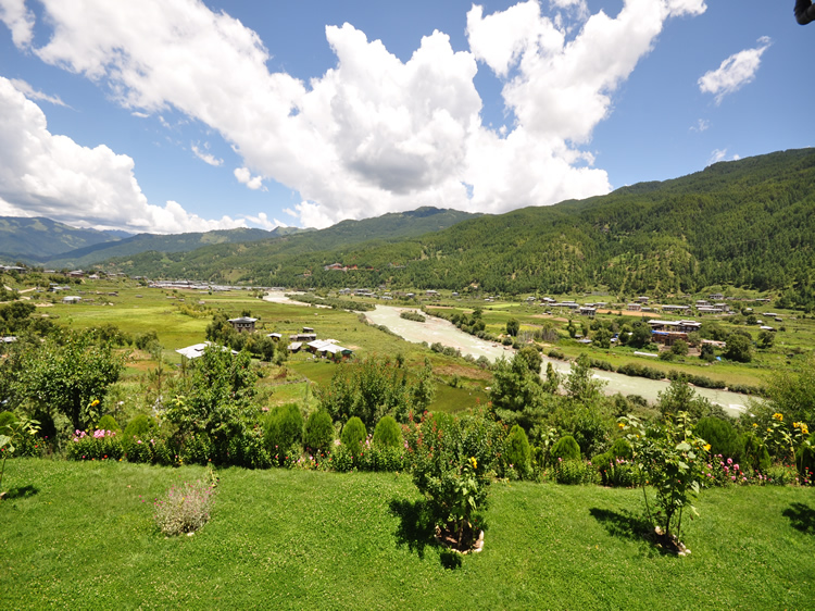 Rolling green valley of Bumthang dotted with farmhouses and temples, Bhutan.