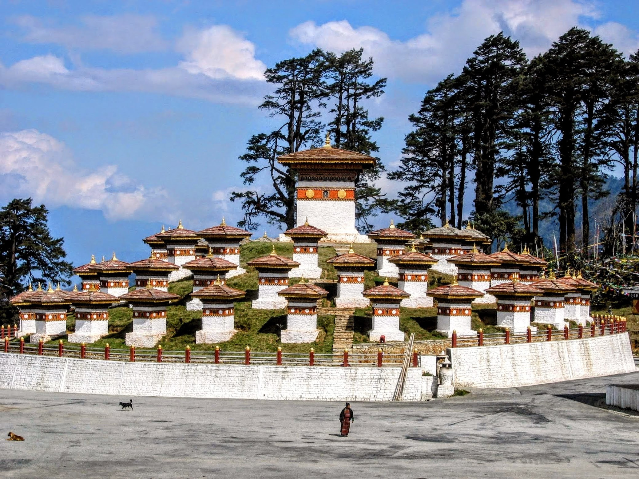 Dochula Pass in Bhutan with 108 Druk Wangyel Chortens surrounded by Himalayan mountains and pine forests.
